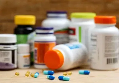 pill bottles and pills on a wooden table